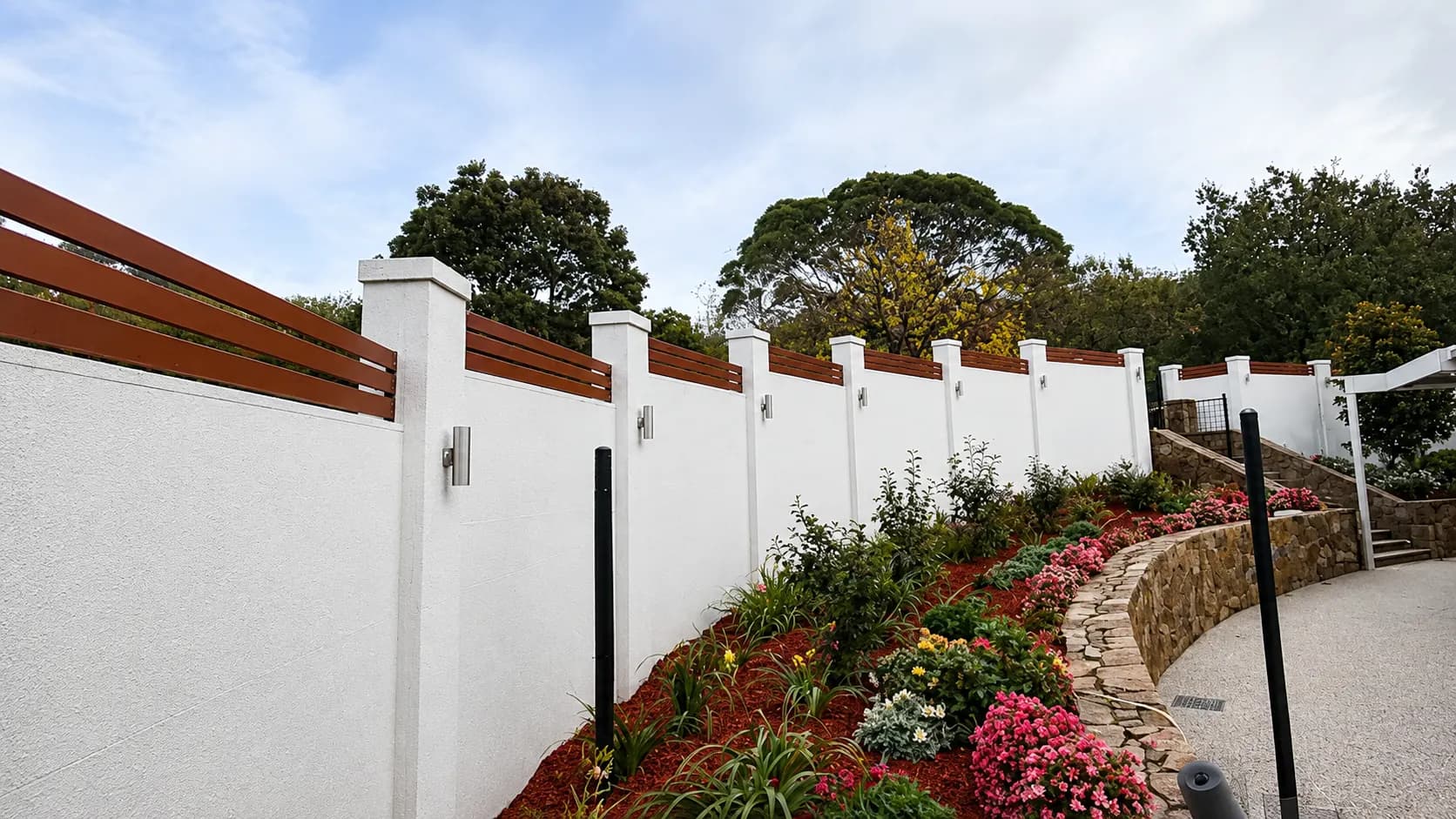 Rendered feature boundary wall with timber slat infill and garden lighting